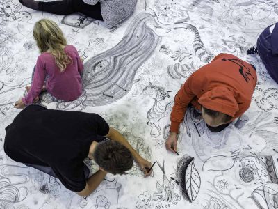 Three Children Drawing on Floor